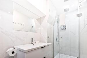蒙特利尔Parc Avenue Hostel的白色的浴室设有水槽和淋浴。