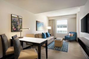 圣安东尼奥Embassy Suites By Hilton San Antonio Landmark的客厅配有沙发和桌子。