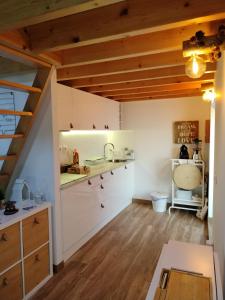 维亚纳堡I Loft Viana的厨房配有白色橱柜和木制天花板。