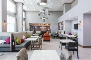 达拉斯Hampton Inn & Suites Dallas East的餐厅设有桌子、沙发和桌椅