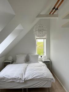 Brundby朗姆罗姆酒店的白色的窗户客房内的一张白色的床