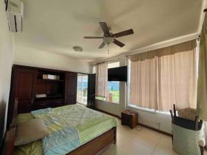 埃尔莱马特Villa Florita Beach House的一间卧室配有一张床和吊扇