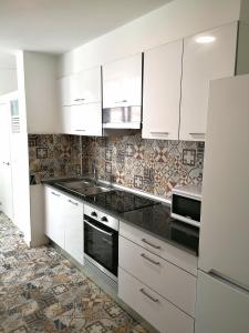 费罗尔Alojamiento céntrico con encanto的厨房配有白色橱柜和水槽