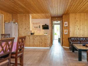 格莱斯堡6 person holiday home in Glesborg的客厅设有木墙和木制天花板