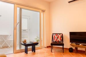 塔维拉Casa do Terreiro的客厅设有滑动玻璃门和椅子