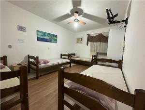 里贝朗普雷托Pousada Anhanguera的客房设有四张床和吊扇。