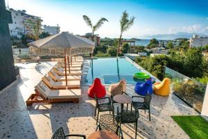 卡萨米尔Sunlight Hotel的一个带椅子的庭院和一个游泳池