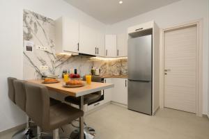 卡诺尼Kukos Apartment Corfu的厨房配有桌子和冰箱