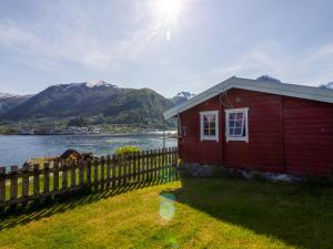 巴里斯川Holiday Home Naustvollen - FJS123 by Interhome的水体旁有栅栏的红色房子