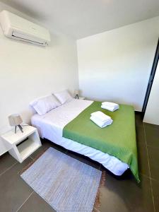 蒙丁-迪巴什图Casa Amarela - Mondim de Basto的一间卧室配有一张带绿毯的床