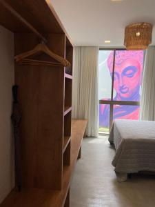 佩德拉斯港Lotus Patacho的卧室配有一张床,窗户上画着画作