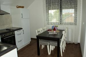 圣马丁娜穆里Kraljeva hiža - Apartmani i sobe Kralj的厨房配有黑桌和白色橱柜