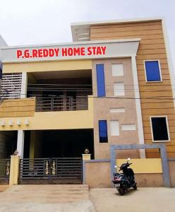 蒂鲁帕蒂P. G. REDDY HOME STAY的停在民宿前的摩托车