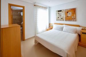 埃尔切ECO-MANOLITA的卧室配有白色的床和窗户。