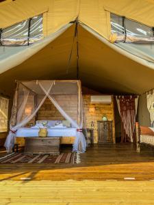 萨杜勒尼亚TERRA - Saturnia tented lodges的房间里的帐篷里的一张床位
