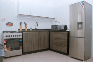 林贝Candide Guest House的厨房配有冰箱和炉灶。