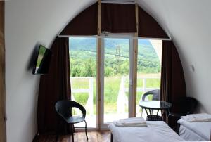 ShahumyanGlamping Eco Valley的客房设有两张床、一张桌子和一扇窗户。