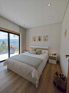 Santa Cruz do DouroCasa da Milinha - Villa with a Pool near Rio Douro的一间卧室设有一张大床和一个大窗户