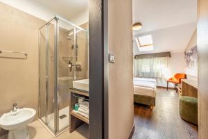 齐亚诺迪菲耶姆梅Suàn Hotel的带淋浴、卫生间和盥洗盆的浴室