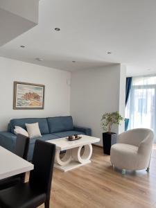 斯韦蒂·斯特凡Villa Milan的客厅配有蓝色的沙发和桌子