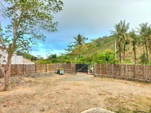 龙目岛库塔Bulan Biru的棕榈树庭院前的围栏