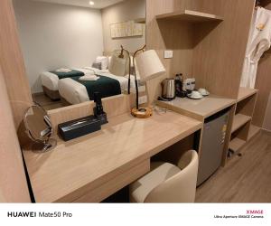 合艾Chinatown Living Hatyai的酒店客房配有一张床、一张书桌