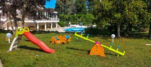 马丁纳弗兰卡Villa del Sole Martina Franca的一群在草地上玩耍的儿童游乐场设备