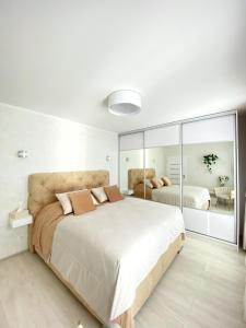 布拉迪斯拉发Die Eleganz - Exclusive Apartment near the City Center的一间卧室配有一张大床和镜子