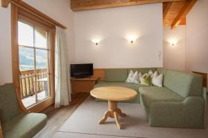 阿尔卑巴赫落叶松旅馆的客厅配有沙发和桌子