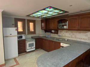 萨法加Marina 4的厨房配有木制橱柜和天花板上的窗户。