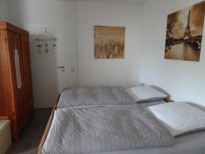 布伦Ferienwohnung Büren-Harth的卧室配有一张床,墙上挂有两张照片