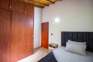 麦德林Apartamento a 3 min del Hospital Pablo tobón uribe的一间卧室配有一张床和一个木制橱柜