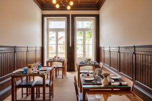 波尔图Casa do Arquiteto - Townhouse - Architect's House的用餐室设有桌椅和窗户。
