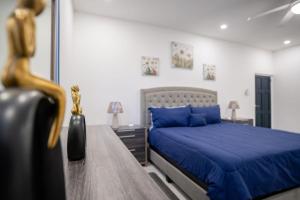 拉纳韦贝Serenity Haven - Your Ultimate Runaway Bay Escape的一间卧室配有一张蓝色的床和一张桌子