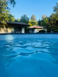 斯塔多伊兰Fuk-tak's bungalow的一座房子前面的蓝色海水游泳池