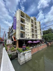 曼谷考巴豪斯酒店的水体旁边的建筑物