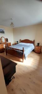 多尼戈尔Biddys cottage的一间卧室配有一张大木床。
