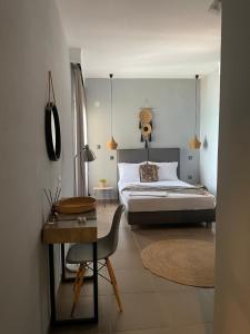 佩科霍里Xenios Hotel的卧室配有1张床、1张桌子和1把椅子