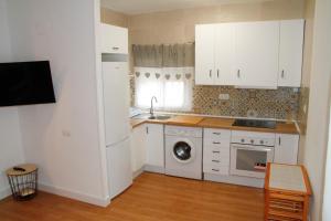 代尔特布雷Antich Apartment Deltebre的厨房配有白色橱柜和洗衣机。