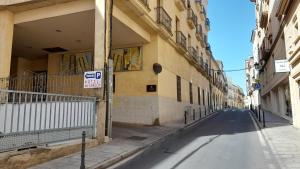 卡塞雷斯Olivae Hostal Boutique的两座建筑之间的小巷里一条空的街道