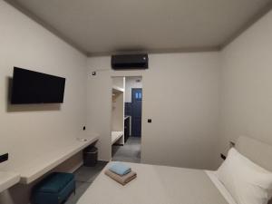 帕罗奇亚Meridiano的卧室配有一张床,墙上配有电视。