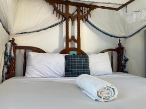 蒙巴萨The Beach House by Maasai的两张带白色床单和毛巾的床