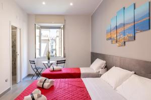 那不勒斯Partenope Guest House的一间带两张床的卧室和红色地毯