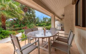 维亚斯Lovely Home In Vias With Outdoor Swimming Pool的庭院内带桌椅的用餐室