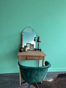法尔肯堡Casa Verde Valkenburg的梳妆台、镜子和绿色椅子
