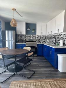 伊斯拉莫拉达Breezy Palms Resort的厨房配有蓝色橱柜和木桌