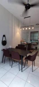 古达S99 HOMESTAY KUDAT的一间带桌椅的用餐室和一间厨房