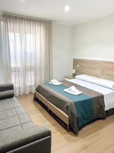 San Costantino AlbaneseTempio Aurora的一间卧室配有一张大床和一张沙发