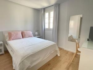 维拉加尔西亚·德·阿劳萨Casa Playa Compostela的白色卧室设有一张大床和镜子