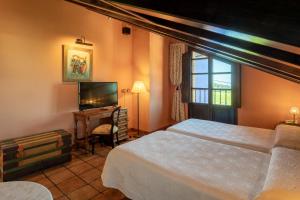 纳隆河畔穆罗斯Globales Playa de Las Llanas的一间卧室配有两张床和一台平面电视